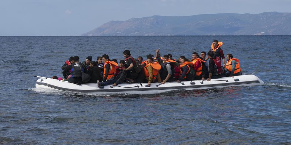 An inflatable boat filled with refugees and other migrants approaches the north coast of the Greek island of Lesbos. Turkey is visible in the background. More than 500,000 migrants have crossed from Turkey to the Greek islands so far in 2015. (An infl