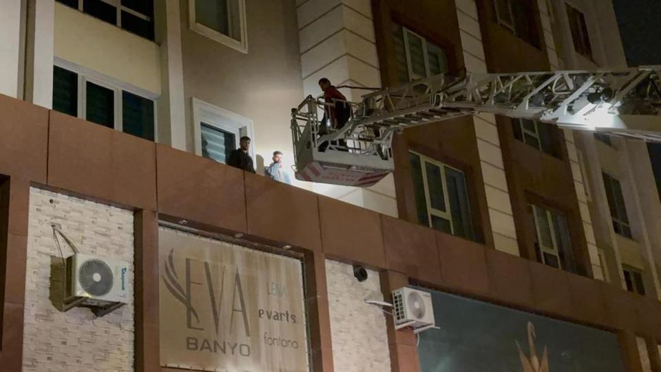 Çarşafla kaçmak isteyen iki kişi market çıkıntısında mahsur kaldı