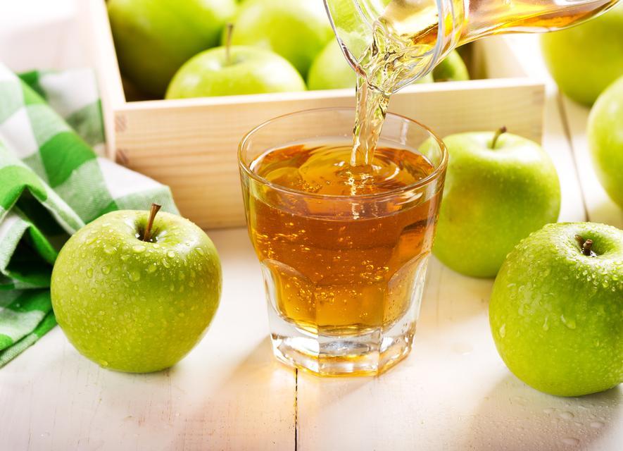 glass of apple juice with fresh fruits on wooden table